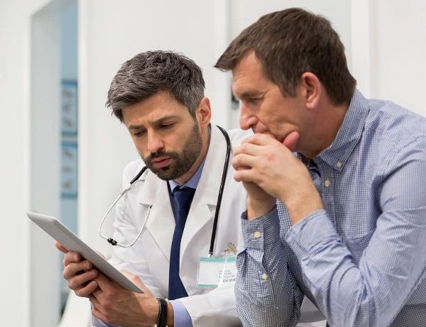 Man sitting with doctor